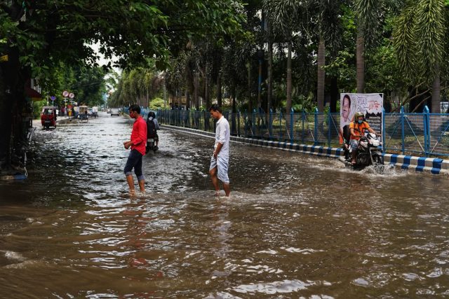 Rescuers search through mud and debris in a Himalayan foothill village after monsoon landslides struck northern India.