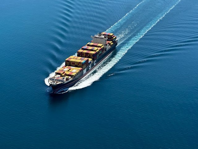 Greek coast guard vessel scanning rough Aegean waters near Lesbos for missing cargo ship crew members