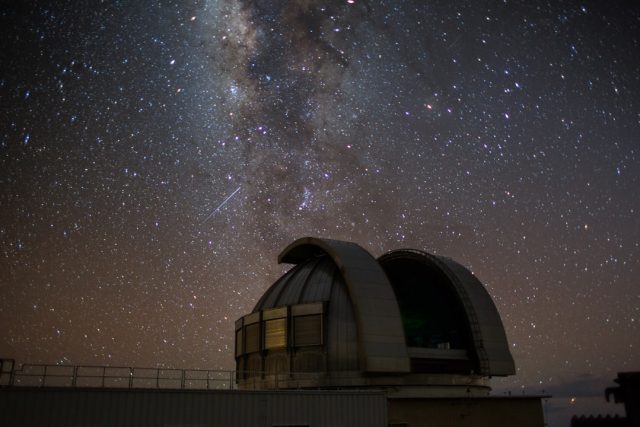 Graduate Student Madyson Barber Leads Discovery of Newborn Exoplanet A graduate student points at a telescope image showing a newborn exoplanet in its early formation stage.