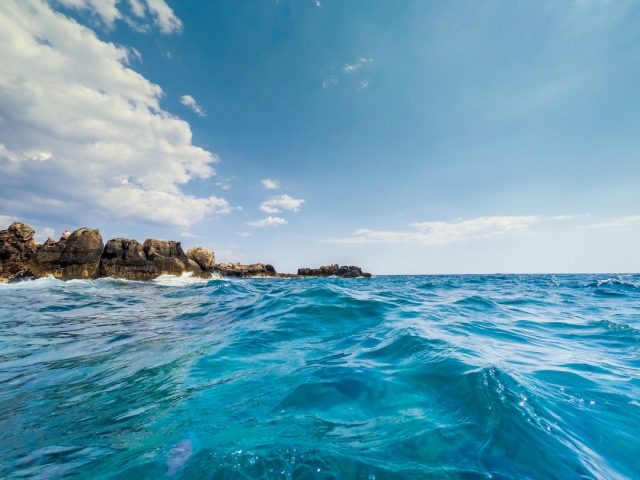 Families of 44 Sierra Leone Refugees Face Uncertain Grief After Capsizing A capsized wooden boat floats in rough Mediterranean waters off the Tunisian coast near Sfax.