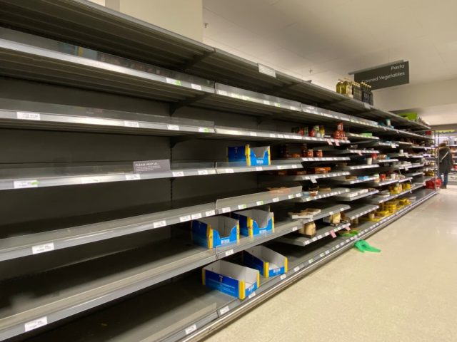 Empty shelves in a World Food Programme warehouse in Gaza, with no grain or cooking oil visible, highlighting the humanitarian crisis.