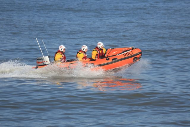 Rescuers pull survivors from the Atlantic Ocean near a capsized wooden boat off the coast of Mauritania.