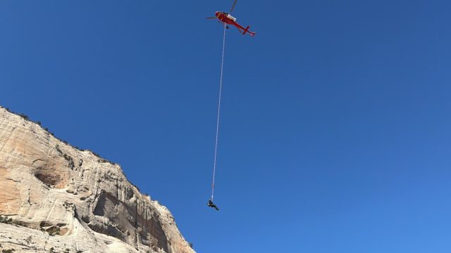 Rescue helicopters hover over snow-covered Tosc Mountain after an avalanche swept three Croatian climbers.