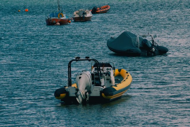 Rescue workers carry a survivor from the waves as recovered bodies line Mahdia’s dock after the migrant boat sank.