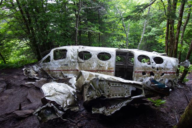 Rescue teams walk the rugged crash site where a white SATENA Beechcraft 1900 lies broken near Cúcuta