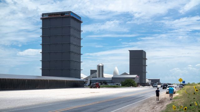 SpaceX Starship rocket booster caught by the arms of the launch tower at the Starbase facility in Texas during a test flight.