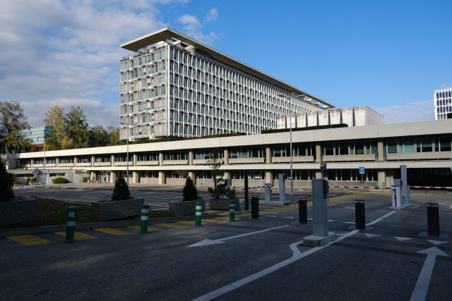 World Health Organization headquarters in Geneva with a flag and modern building exterior