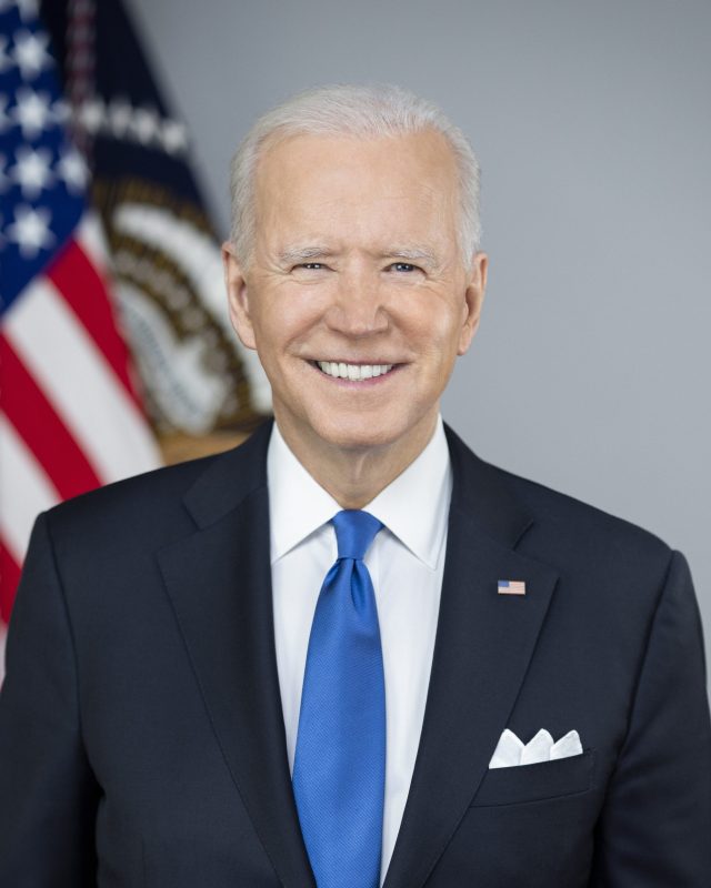 President Joe Biden speaks at a podium with a presidential seal, announcing his 2024 re-election campaign