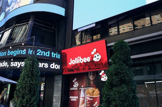 Jollibee fast-food restaurant exterior with customers entering and exiting the building.