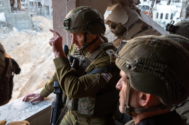 IDF soldiers patrol a dusty street in Rafah, Gaza, after a firefight that killed Hamas leader Yahya Sinwar.