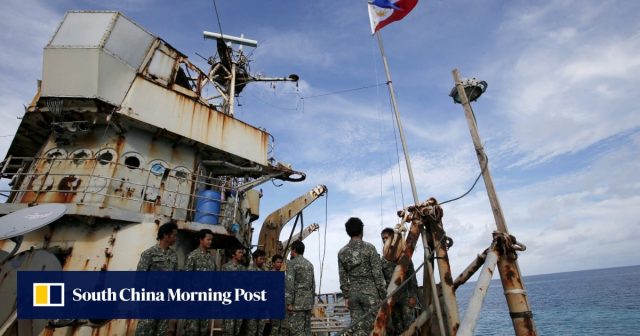 Philippine military personnel monitor a Chinese warship grounded near Scarborough Shoal in the South China Sea.