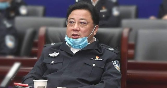 A courtroom scene in Changchun with judges seated behind a bench, hearing the verdict in Sun Lijun's corruption case.
