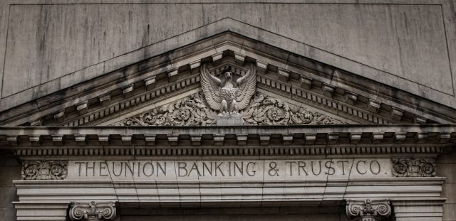 UBS bank building exterior with traders working at desks in a financial district