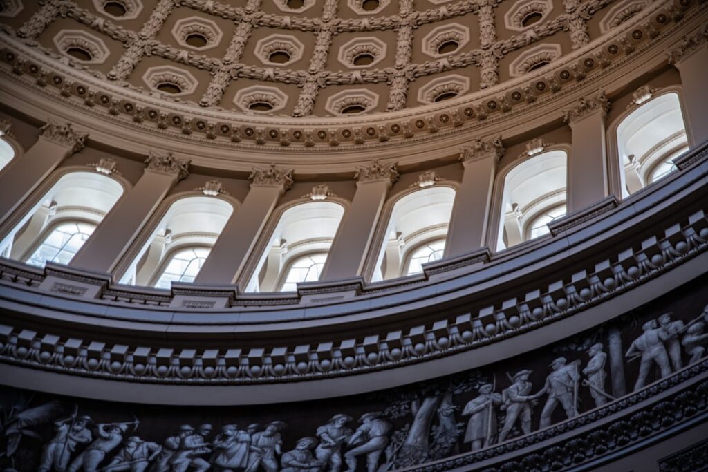 Donald Trump raises his right hand while Chief Justice administers the presidential oath beneath the Capitol rotunda dome.