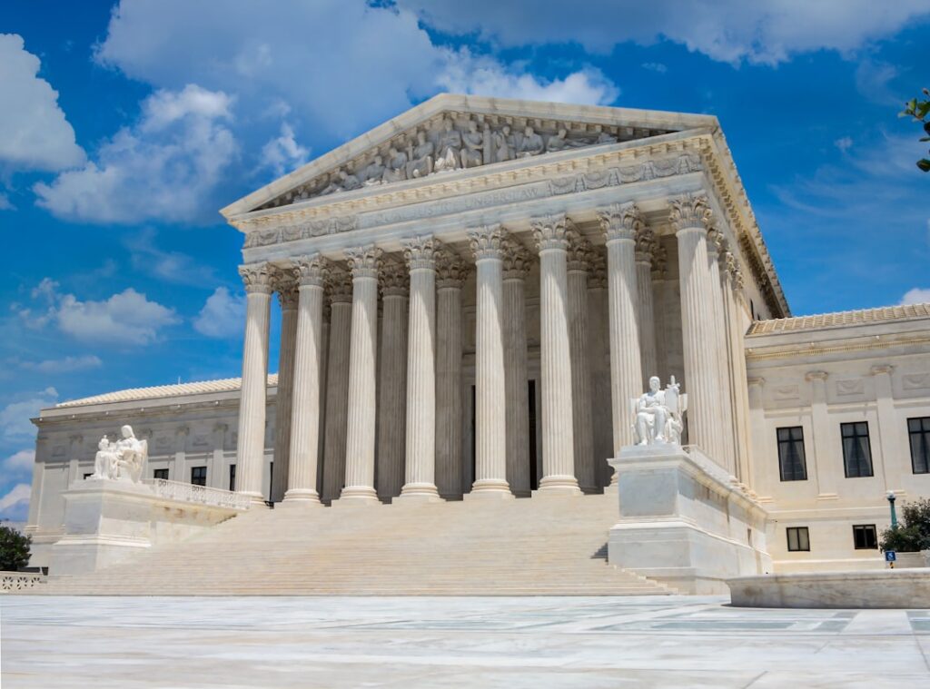 Lawyers walk up the Supreme Court steps carrying briefs labeled TikTok v. Garland under a January deadline banner.