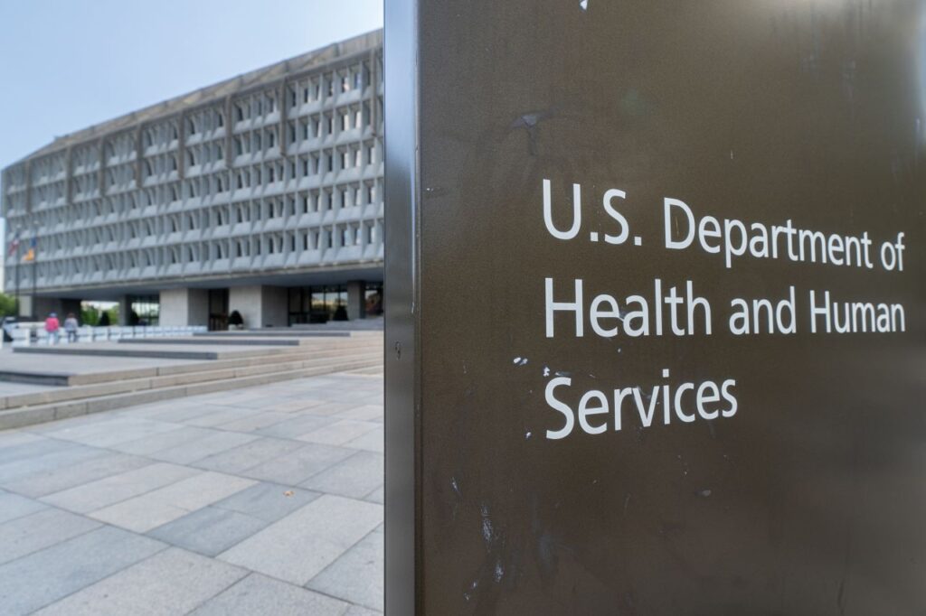 HHS headquarters building with a sign reading U.S. Department of Health and Human Services in Washington D.C.
