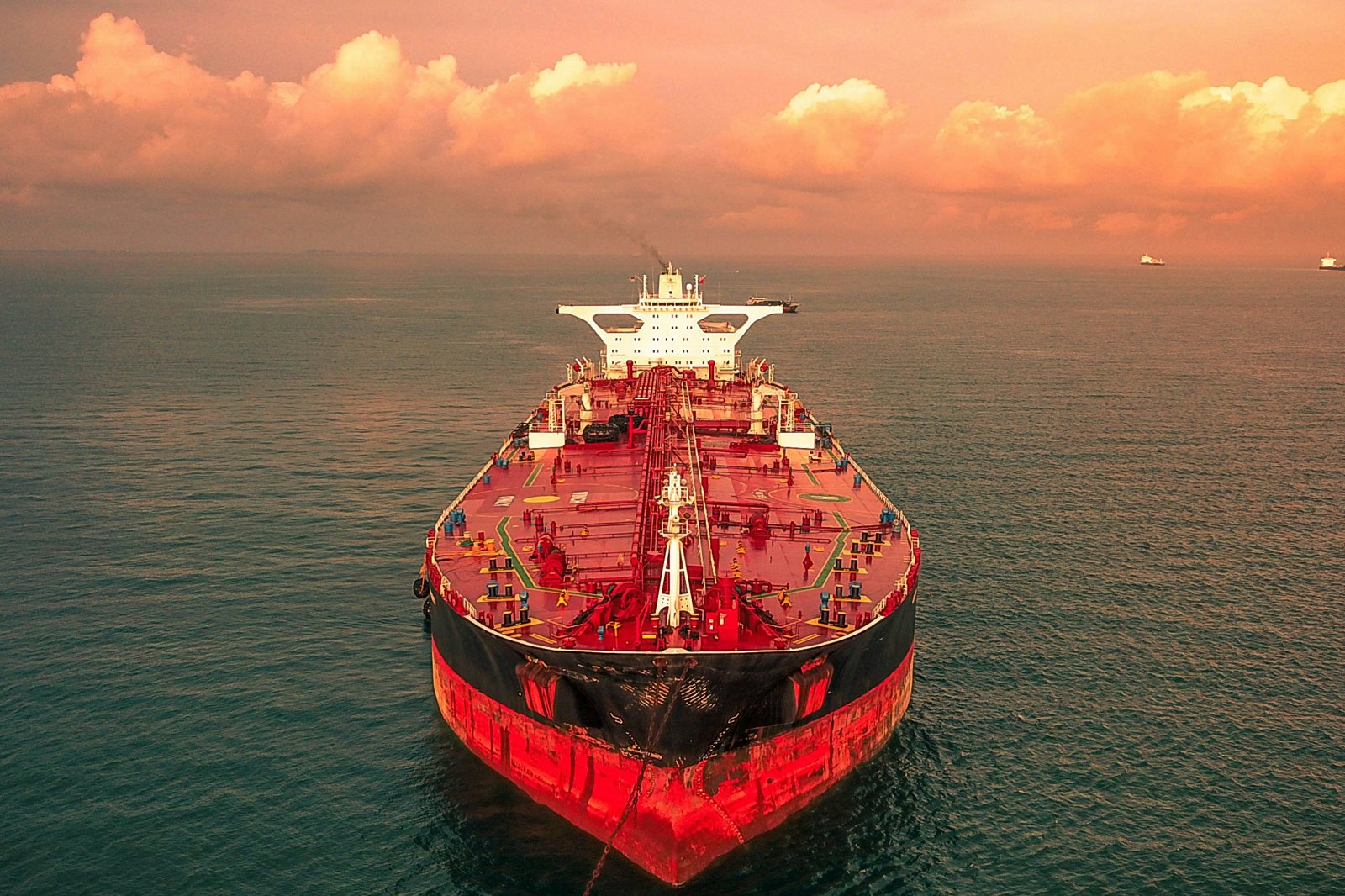 red and white ship on sea under cloudy sky during daytime